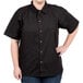 A woman wearing a black Chef Revival cook shirt with short sleeves.