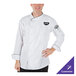 A man wearing a Mercer Culinary white chef coat with black piping.