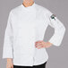 A woman wearing a white Mercer Culinary chef jacket.