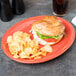 A sandwich and potato chips on a Libbey Cayenne carved porcelain oval platter.