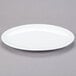 A white oval Libbey Aluma White porcelain platter on a gray surface.