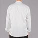 A man wearing a white Mercer Culinary chef jacket with a white background.
