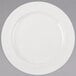 A Libbey ivory porcelain plate with a white rim on a gray background.