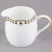 A white and gold Syracuse China Baroque creamer with a design on the handle.