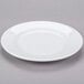 A Libbey white porcelain plate with a rim on a gray surface.