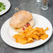 A Libbey ivory porcelain plate with a sandwich and chips.