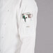 A white Mercer Culinary chef's coat with red piping and pockets.