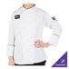 A woman wearing a white Mercer Culinary chef coat with black piping.