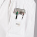 A Mercer Culinary Renaissance women's white chef jacket with red piping and a pocket full of medical tools.
