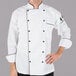 A man wearing a Mercer Culinary Renaissance chef's coat with black piping.