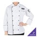 A woman wearing a white Mercer Culinary chef coat with black piping.