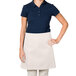 A woman wearing an ivory Intedge waist apron.