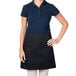 A woman wearing a black Intedge waist apron.