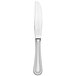 A Libbey stainless steel dessert knife with a pinched bolster and serrated blade with a silver handle and black edges on a white background.