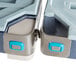 A close-up of a metal container hanging from Metro shelving with a white liquid inside using a Metro S-Hook.
