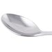 A close-up of a Libbey stainless steel dessert spoon with a silver handle.