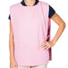 A woman wearing a pink Intedge cobbler apron.