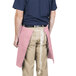 A man wearing an Intedge mauve waist apron.