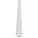 A close up of a Libbey Aegean stainless steel iced tea spoon.