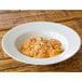 A 10 Strawberry Street Royal White wide rim porcelain soup bowl filled with pasta and cheese.