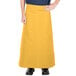 A person wearing a yellow Intedge bistro apron.