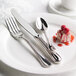 A white plate with a Libbey stainless steel bread and butter knife on it.