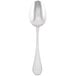 A silver Libbey serving spoon with a white handle.