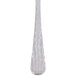 A close up of a Libbey stainless steel iced tea spoon with a white handle.