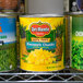 A shelf with Del Monte canned pineapple chunks on it.