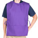 A man wearing a purple Intedge cobbler apron with black trim.