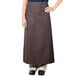 A woman wearing a brown Intedge bistro apron.