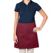 A woman wearing a burgundy Intedge waist apron.