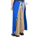 A person wearing a blue Intedge bistro apron.