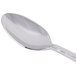 A Libbey stainless steel demitasse spoon with a silver handle.