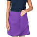 A woman wearing a purple Intedge waist apron.