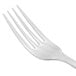 A close-up of a Libbey stainless steel dinner fork with a white handle.