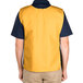 A man wearing a gold Intedge cobbler apron with two pockets.