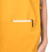 The back pocket of a yellow Intedge cobbler apron.