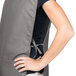 A woman wearing a gray Intedge cobbler apron with a grey belt.