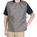 A man wearing a gray Intedge cobbler apron over a black shirt.