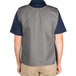 A man wearing a gray Intedge cobbler apron with two pockets.