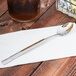 A Libbey stainless steel iced tea spoon on a napkin.