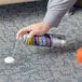 A person spraying Spot Shot carpet stain remover on a white carpet.