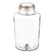 An Acopa clear glass beverage dispenser with a red lid and tap.