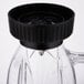 A clear Waring blender jar with a black plastic lid.