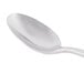 A Libbey stainless steel demitasse spoon with a silver handle.