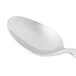A Libbey stainless steel dessert spoon with a white handle.