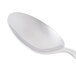 A Libbey stainless steel serving spoon with a white handle.