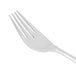 A Libbey stainless steel dinner fork with a white handle.