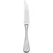 A silver steak knife with a white handle.